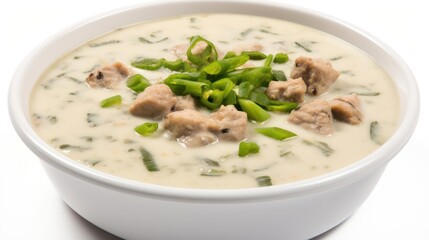 Creamy meat soup garnished with fresh green onions.