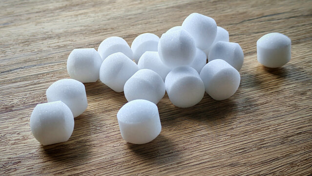 White naphthalene balls on blue background.