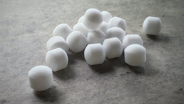 White naphthalene balls on gray background.