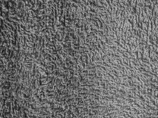 Detailed macro shot showcasing the intricate texture of gray terrycloth. This image emphasizes softness and comfort, ideally suited for backgrounds and textile design projects.