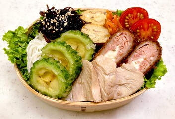 A colorful dosirak lunchbox filled with neatly arranged rice, savory protein, and assorted side dishes. A portable feast that captures the essence of authentic Korean home-style cooking.