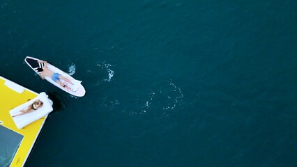 A young couple are enjoying seaside adventure aboard a yacht
