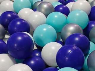 A captivating close-up showcases a playful arrangement of colorful plastic balls, ideal for...