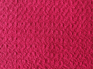 A vibrant crimson texture offers a striking visual, ideal for backgrounds and graphic design. This closeup displays the fabric's plush pile and depth, creating a soft and inviting impression.