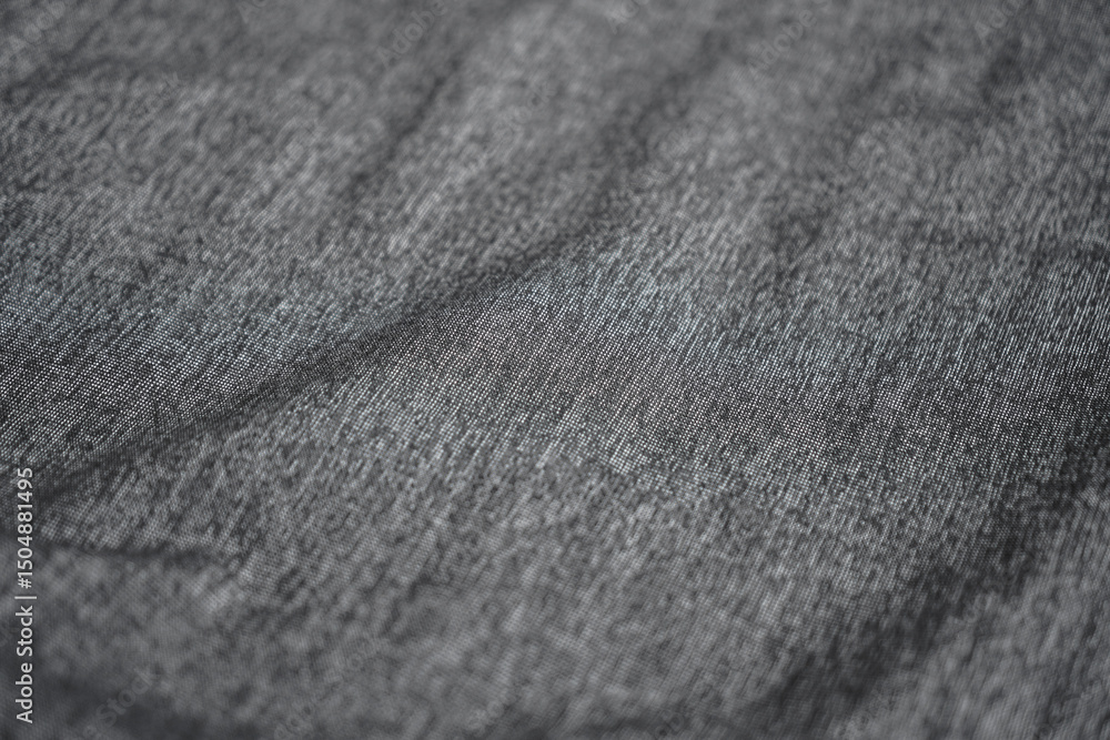 Poster a close-up showcases the intricate texture of a gray fabric, emphasizing its subtle variations and p