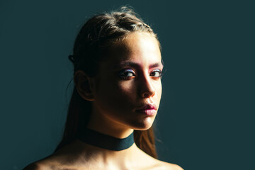 Sensual portrait of a young nude sexy woman. Sensual model posing in studio shadow lighting. Fashion shoot of beauty woman. Sensual model with fashion makeup. Sensual brunette girl.