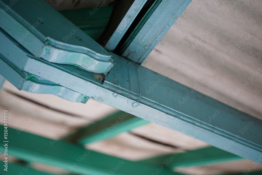 Poster a textured, close-up view reveals layers of painted wood, connected in angular architectural design.