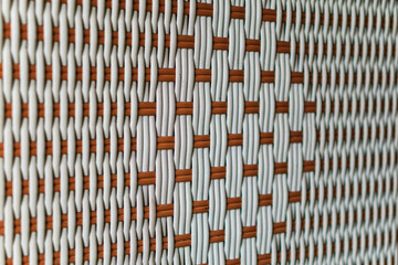 A textured pattern of woven white and brown strands creates an intricate, eye-catching design,...