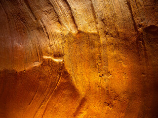 Abstract orange color wall cave scene background. Close-up texture surface of lower stone canyon...