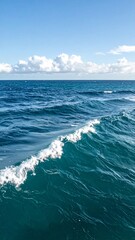 Fototapeta premium Calm ocean waves under a clear sky or light clouds 