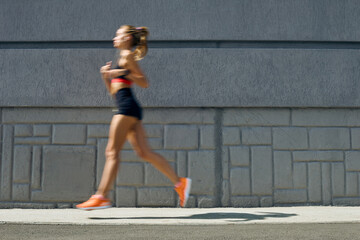 Woman jogging outdoors, motion concept