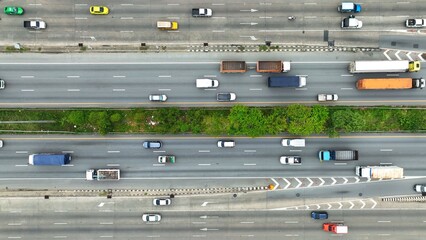 An aerial canvas reveals the intricate patterns of urban travel. Cars, buses, and a solitary...