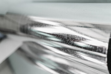 A macro shot showcasing layers of silver metallic material, with a blurred effect creating a...