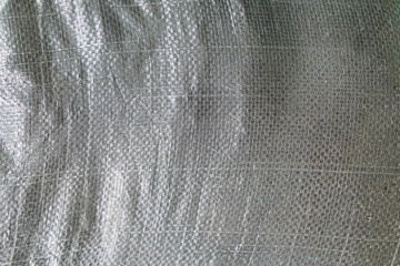An abstract close-up showcases interwoven threads creating a textured, durable material. The...