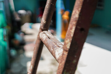 An abstract close-up captures the textures of aging metal. Weathered ladder suggests resilience and...