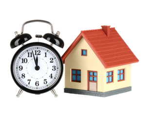 Classic Alarm Clock beside a Small House Miniature with Red Roof and Windows Showing Time Concept