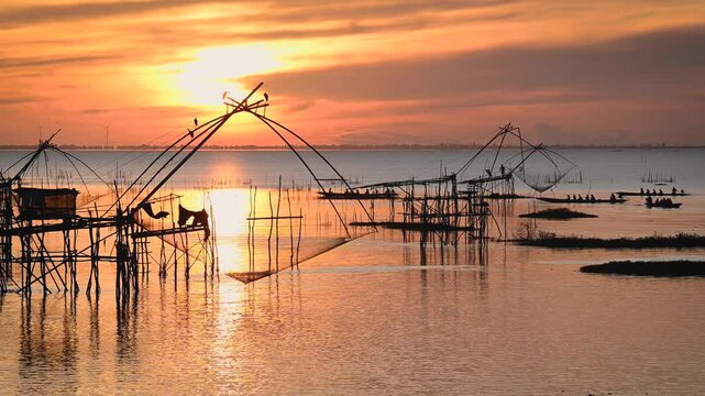 Sunrise Pakpra Lake in the morning with local travel boat in south of Thailand.