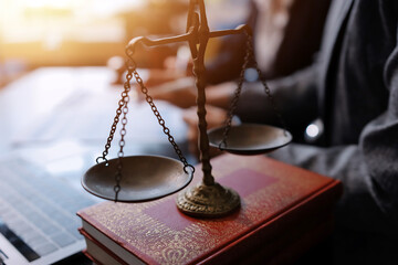 Judge gavel with Justice lawyers having team meeting at law firm background. Concepts of Law and...