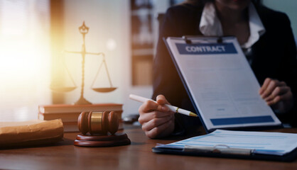 Judge gavel with Justice lawyers having team meeting at law firm background. Concepts of Law and...