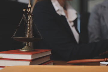 Judge gavel with Justice lawyers having team meeting at law firm background. Concepts of Law and...