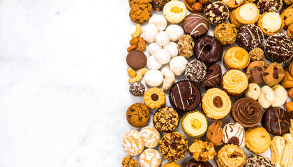 Obraz premium Assorted cookies and pastries laid out on clean white surface
