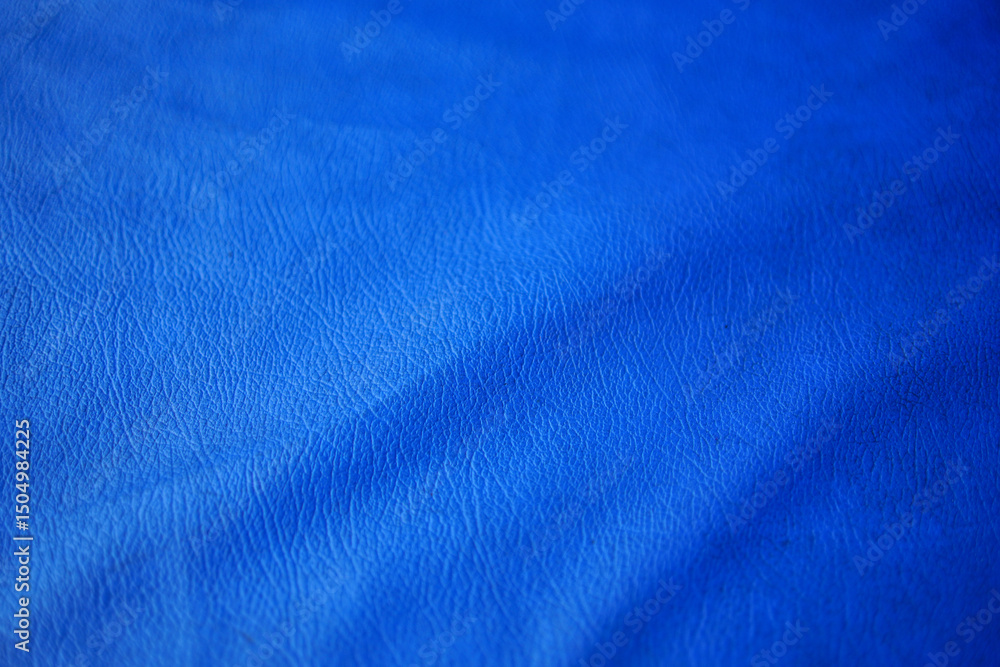 Poster a saturated and vivid blue texture is ideal for backgrounds. the uneven shadows and highlights accen