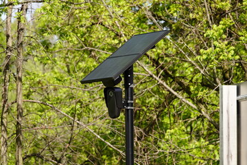 Flock safety police law enforcement license plate reader set up outside to help catch vehicle speeders.