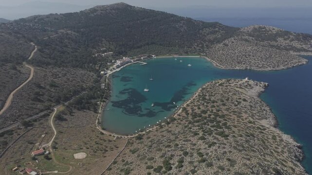 Professional aerial footage documenting the beautiful Panormitis Monastery on Symi island. The drone captures the spiritual sanctuary's unique position nestled between mountains and sea. D-Log M