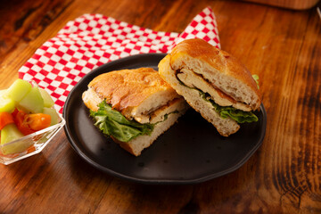 Mexican Chicken Breast Torta. Healthy homemade sandwich with grilled chicken breast, mayonnaise, lettuce, tomato, and other vegetables and toppings.