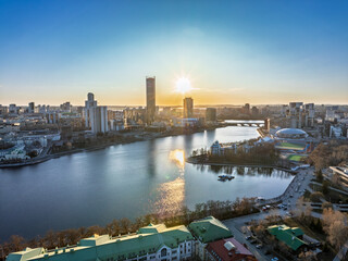 Fototapeta premium Yekaterinburg aerial panoramic view in spring at sunset. Yekaterinburg city and pond in spring or autumn.
