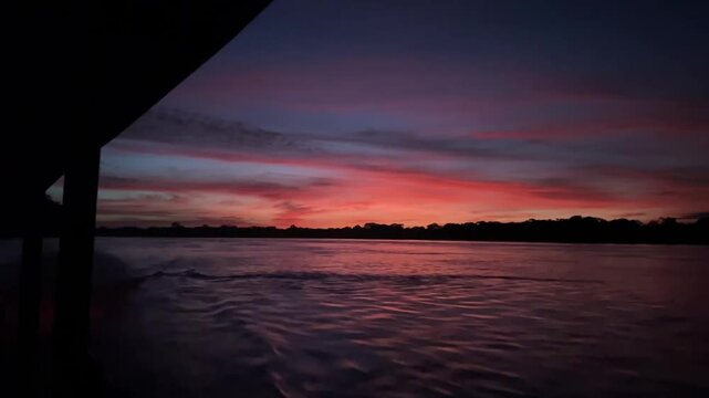 Fiery Amazon River Sunset with Colorful Reflections