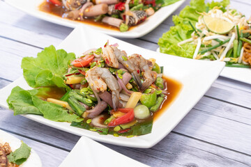 Papaya salad is a spicy, salty, sour Thai food that has ingredients such as papaya, tomatoes, peppers, shrimp, clams and various vegetables.