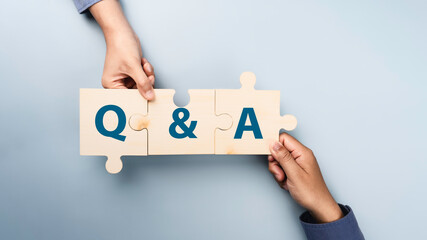 Q&A or Question and Answer Concept. Hand Put the jigsaw together to Q and A - Answer, Question Ask, Information, Communication Concepts on digital platform. FAQ (frequency asked questions)
