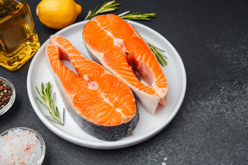 Fresh salmon fillets prepared with herbs and lemon on a kitchen countertop