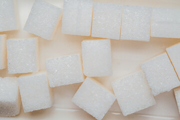 Sugar cubes arranged on a flat surface in a kitchen setting