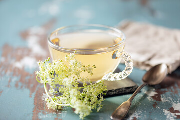 Herbal Tea with Elder flower on wooden background. Healing drink