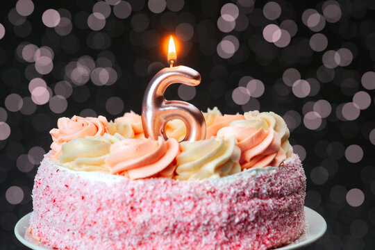 Celebration for a child's sixth birthday with a pink cake and candle - Powered by Adobe