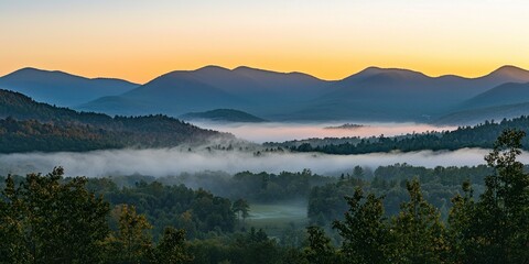 A sunrise scene where mist cascades over a vast mountain range, creating a mystical effect
