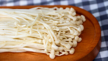 Flammulina filiformis is a species of agaric in the Physalacriaceae family. It is best known for its origin in Japanese cuisine, where it is called enokitake, and is widely cultivated in East Asia.