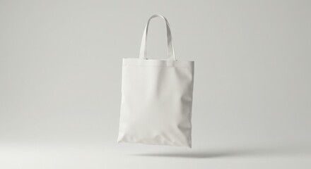 A white tote bag hangs suspended in the air against a bright, neutral background.