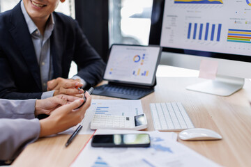 Business team using calculator and laptop for do math finance on wooden desk, tax, accounting,...
