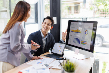 Financial analysts analyze business financial reports on a digital tablet planning investment project during a discussion at a meeting of corporate showing the results of their successful teamwork.	