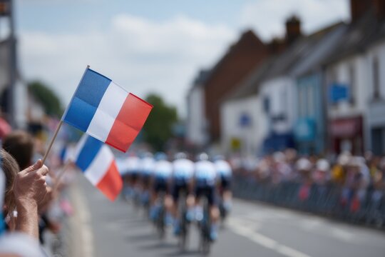 Crowd waving French flag, cyclists racing past shops, vibrant at - Powered by Adobe