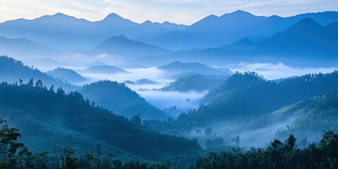 A tranquil valley surrounded by mountains, with soft mist blanketing the lower slopes