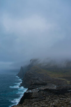 Traelanipa on Vagar island, Faroe Islands, mountain ocean landscape, durring foggy day
