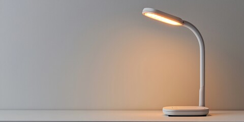 Mini cordless rechargeable desk lamp on white background