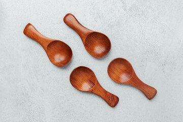 Wooden spoons arranged on a light gray surface for culinary inspiration