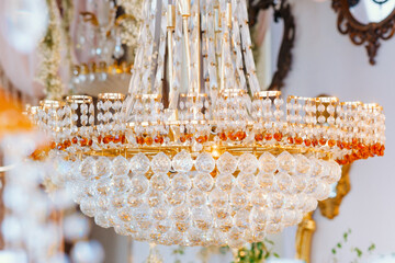 Elegant crystal chandelier hanging in a beautifully decorated venue