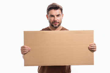Handsome man holding empty board isolated on studio background. Guy showing blank signboard with copyspace. Idea offer. Your advertisement. Blank advertising board with empty space for text, mock up.