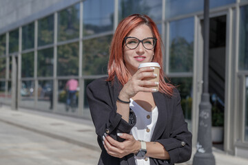 businesswoman holding a takeaway outside the office